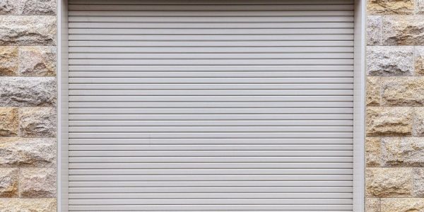 Automatic White Roller Shutter Doors On The Ground Floor Of The