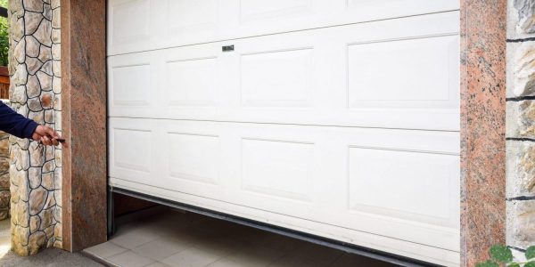 Garage Door Pvc. Hand Use Remote Controller For Closing And Open